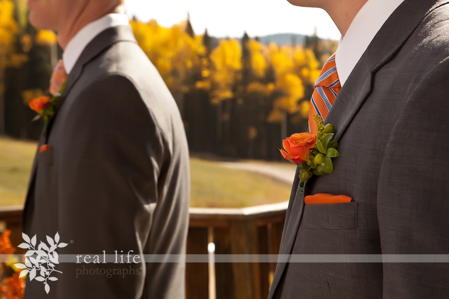 these gorgeous orange boutonnières match the golden and orange fall aspen trees in the background