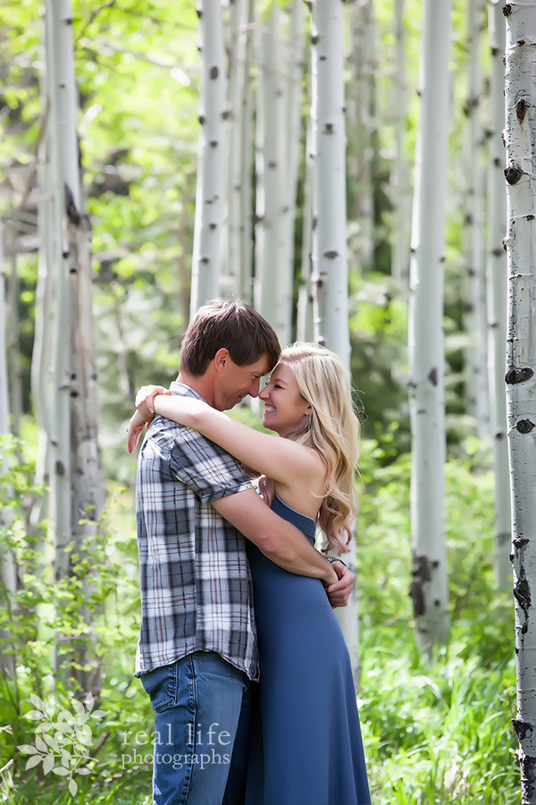 couple embraces in an aspen grove in Ouray, Colorado during their engagement session