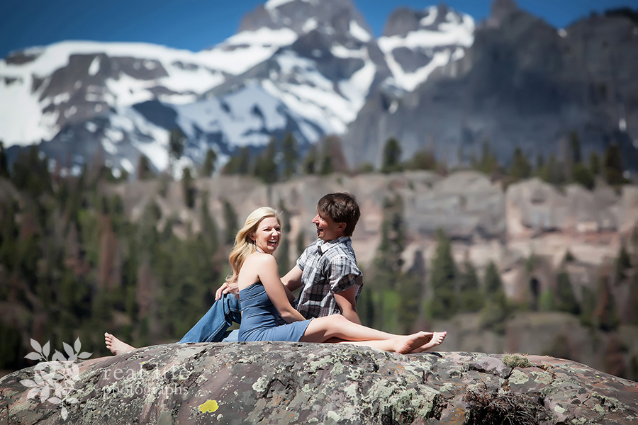 Ouray engagement session in the mountains, couple sitting on the rocks