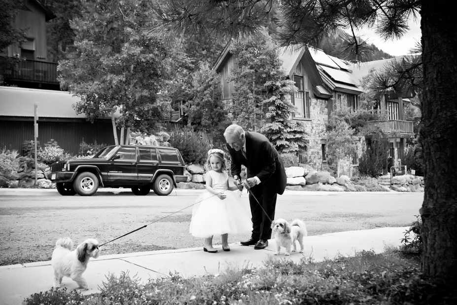Father of the Bride and her niece are walking the dogs before the Telluride wedding.