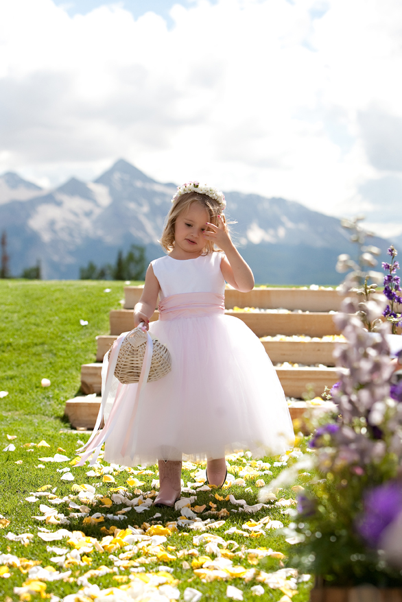 Flower girl walks down the aisle with Mount Wilson in the background.