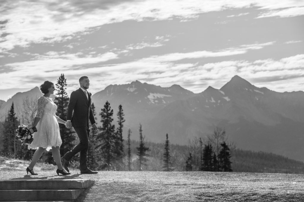 Black and white image of couple walking at San Sophia Overlook with Mount Wilson in the background.