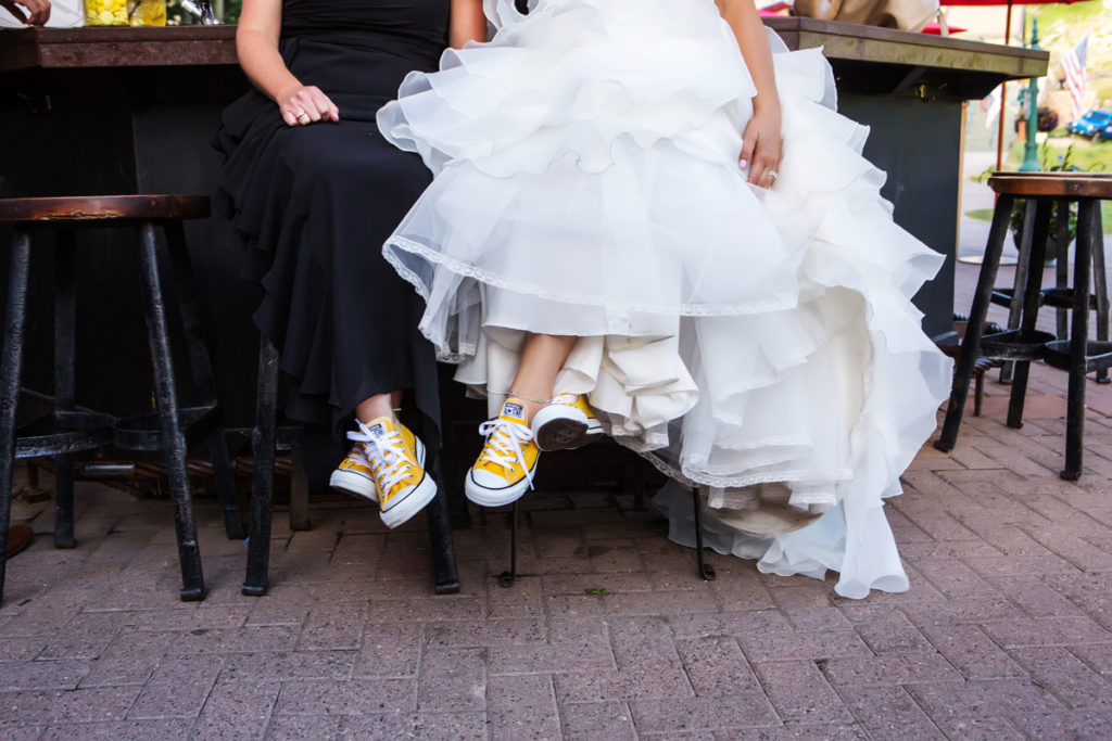 Lesbian wedding reception at Tomboy Tavern in Telluride, Colorado with yellow converse tennis shoes