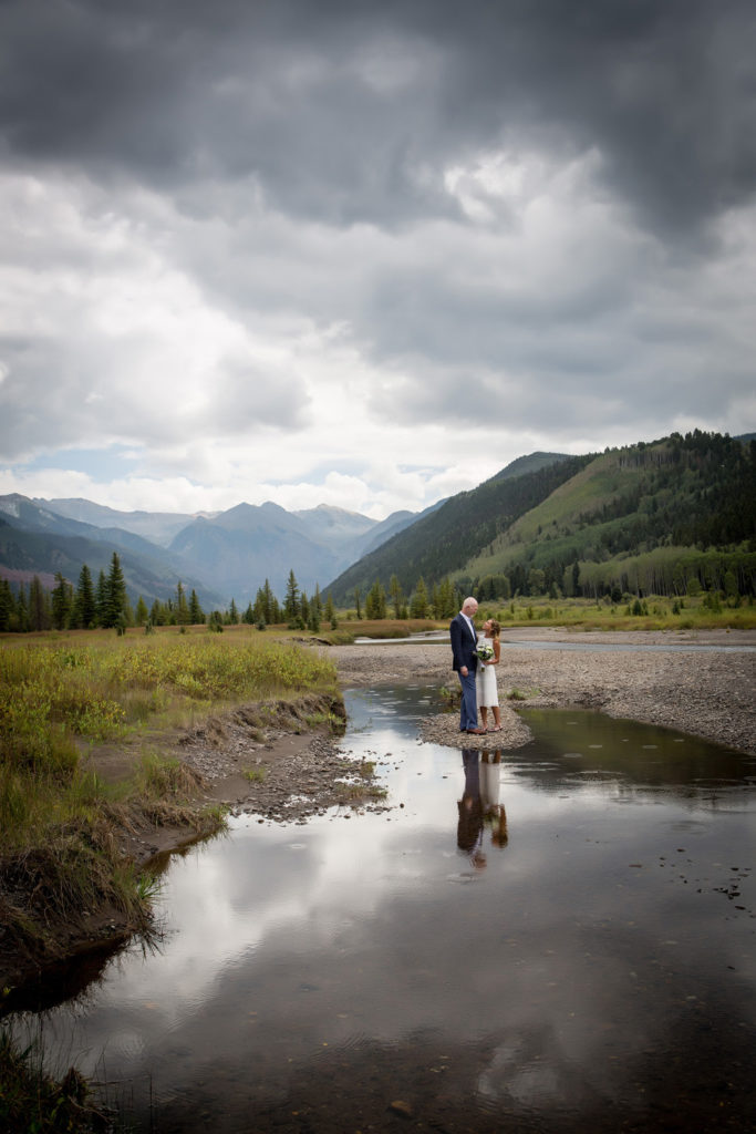 Reflection of the eloped couple on the valley floor as rain drops start to fall.