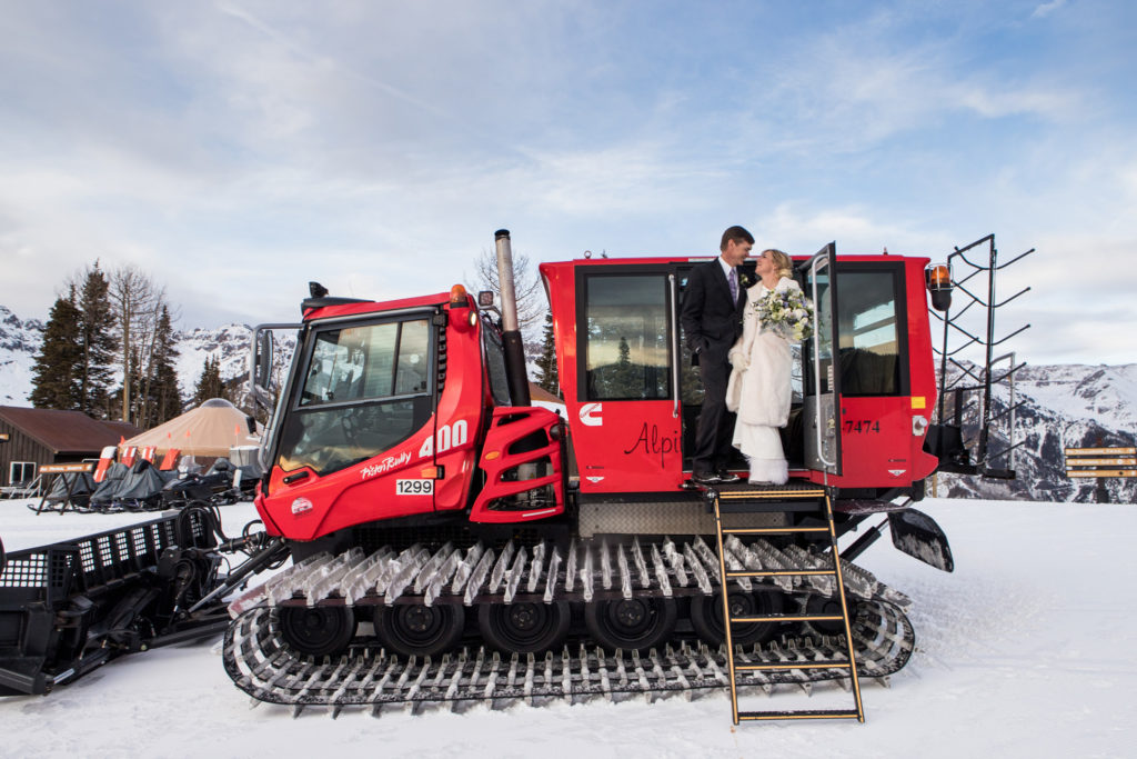 Telluride elopement couple stands on the snow cat on the Telluride ski area