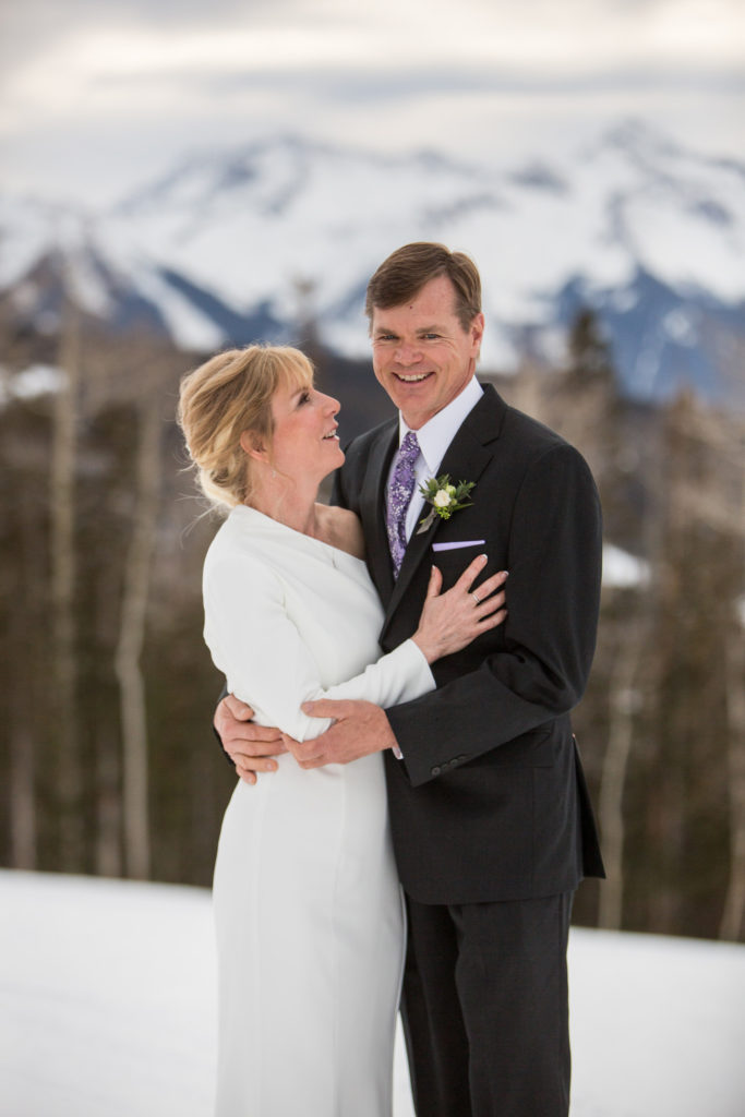 San Sophia Overlook elopement couple embraces in the snow during a spring elopement on the ski area