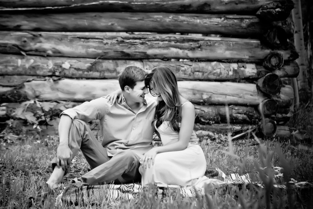 couple sits comfortably for their engagement session.  Tips to help you look natural during your engagement session.
