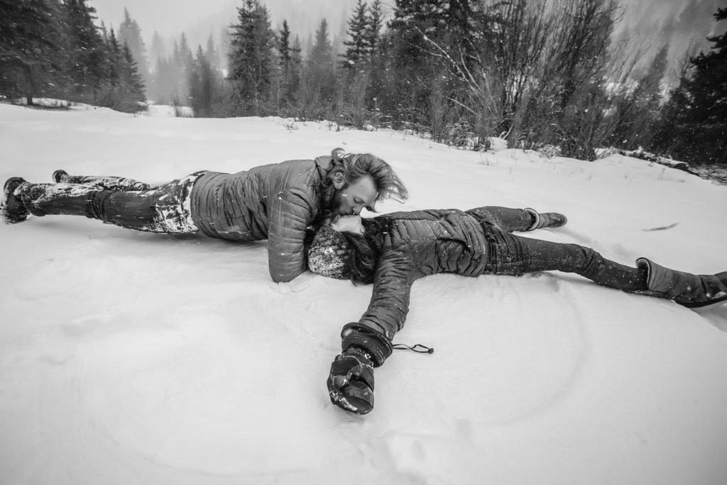 Snow angels at a Telluride winter engagement session in the snow.