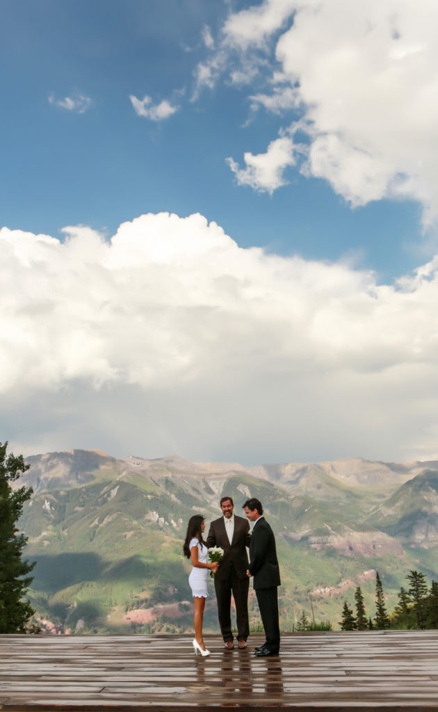 Couple shares their wedding vows in Telluride Colorado with the beautiful mountains in the background