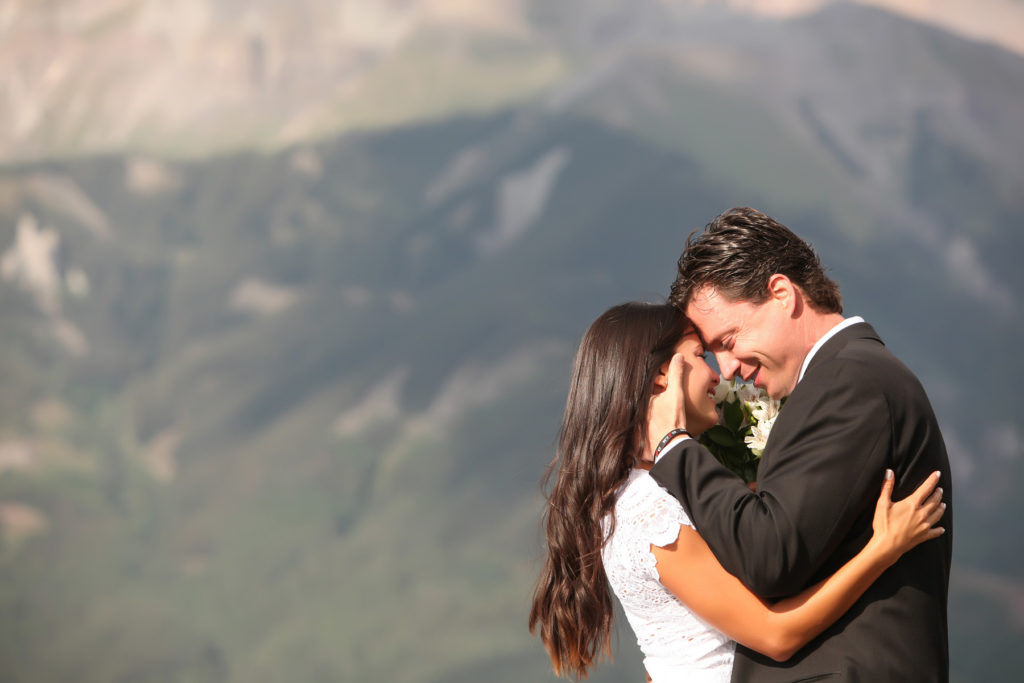 couple shares rings on the deck at San Sophia Overlook in Telluride, Colorado photographed by Telluride wedding photographer Real Life Photographs