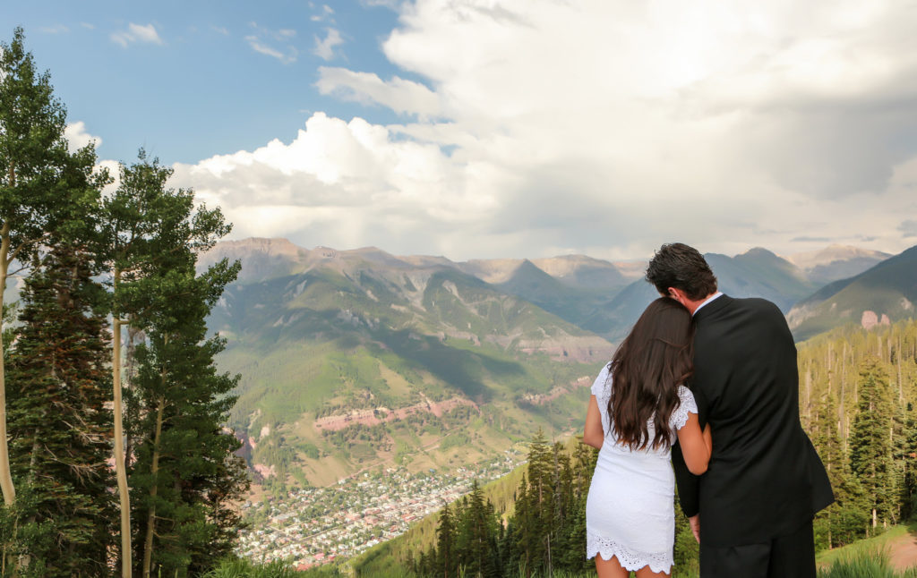Couple at the top of San Sophia Overlook with the town of Telluride in the background