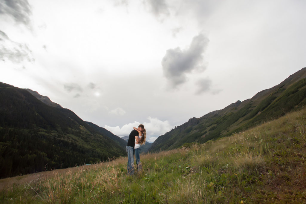 telluride colorado engagement session hug in a field