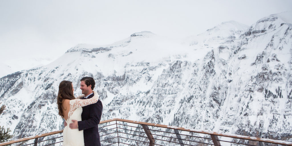 a couple embrace in the middle of winter at the Telluride Tempter House during their first look.