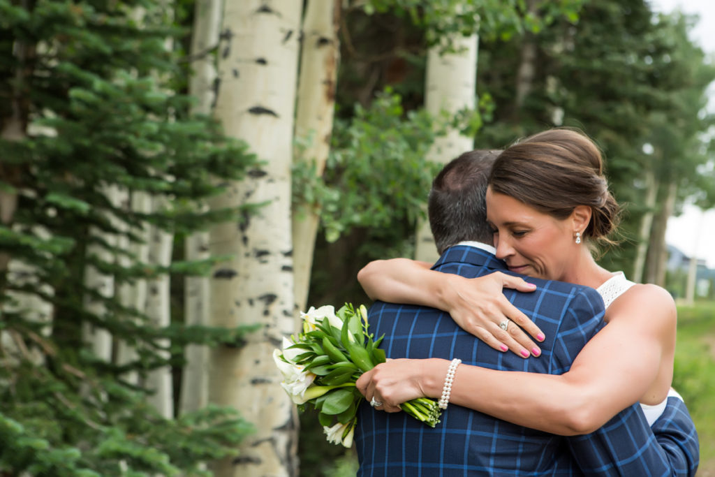 bride and groom hug in the aspen trees of Telluride, Colorado