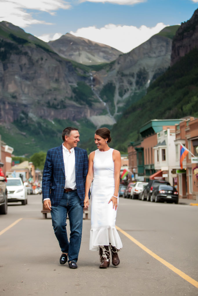 bride and groom walk on Main Street in Telluride, Colorado