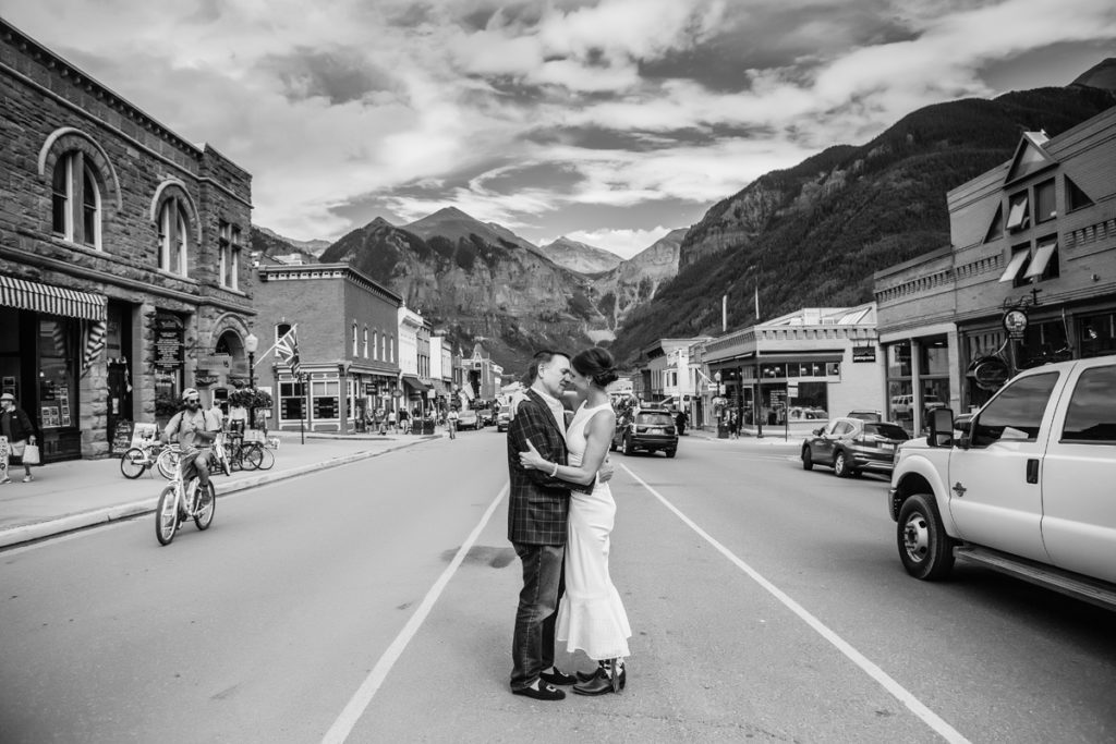 bride and groom walk on Main Street in Telluride, Colorado