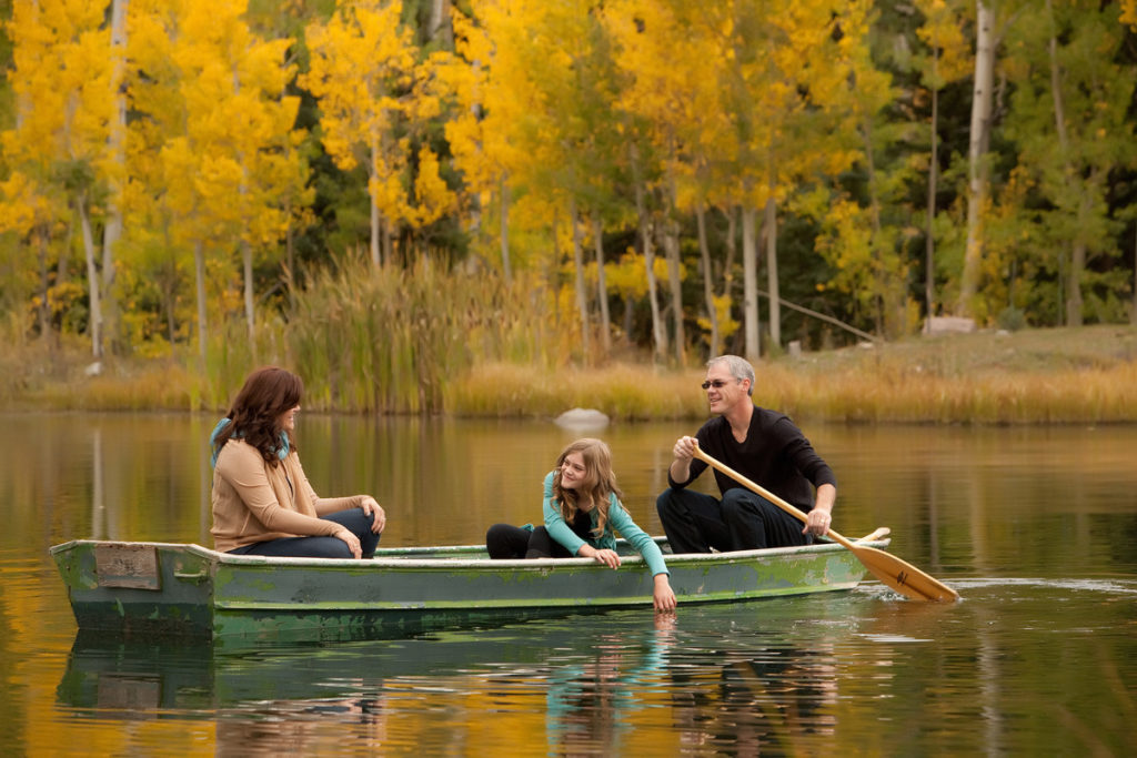 Fall family portrait session in a boat with the colors