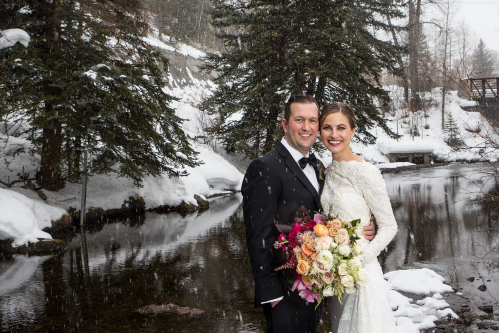 winter Telluride wedding bride and groom on the river in town