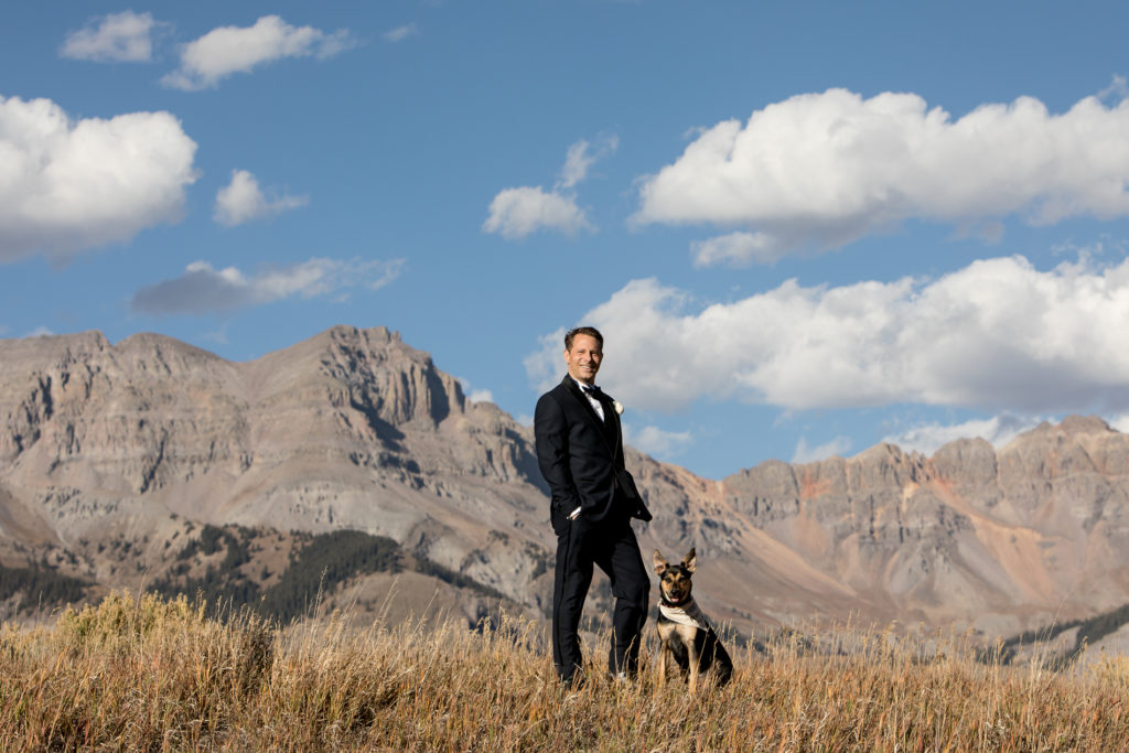 groom and dog in the mountains