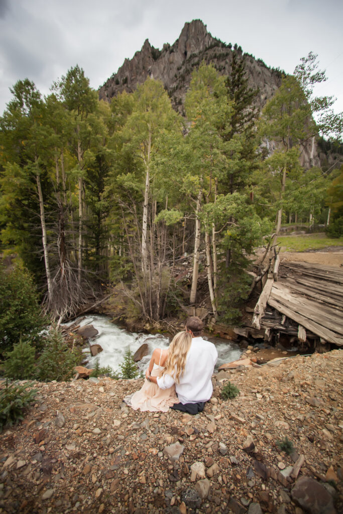 engaged couple near the river with the Ophir needles in the back.