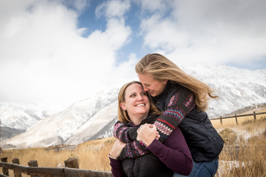 engagement session above the airport with the Telluride mountains behind them.